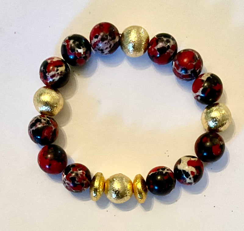 Bracelet with marbled beads and gold accents on a white background