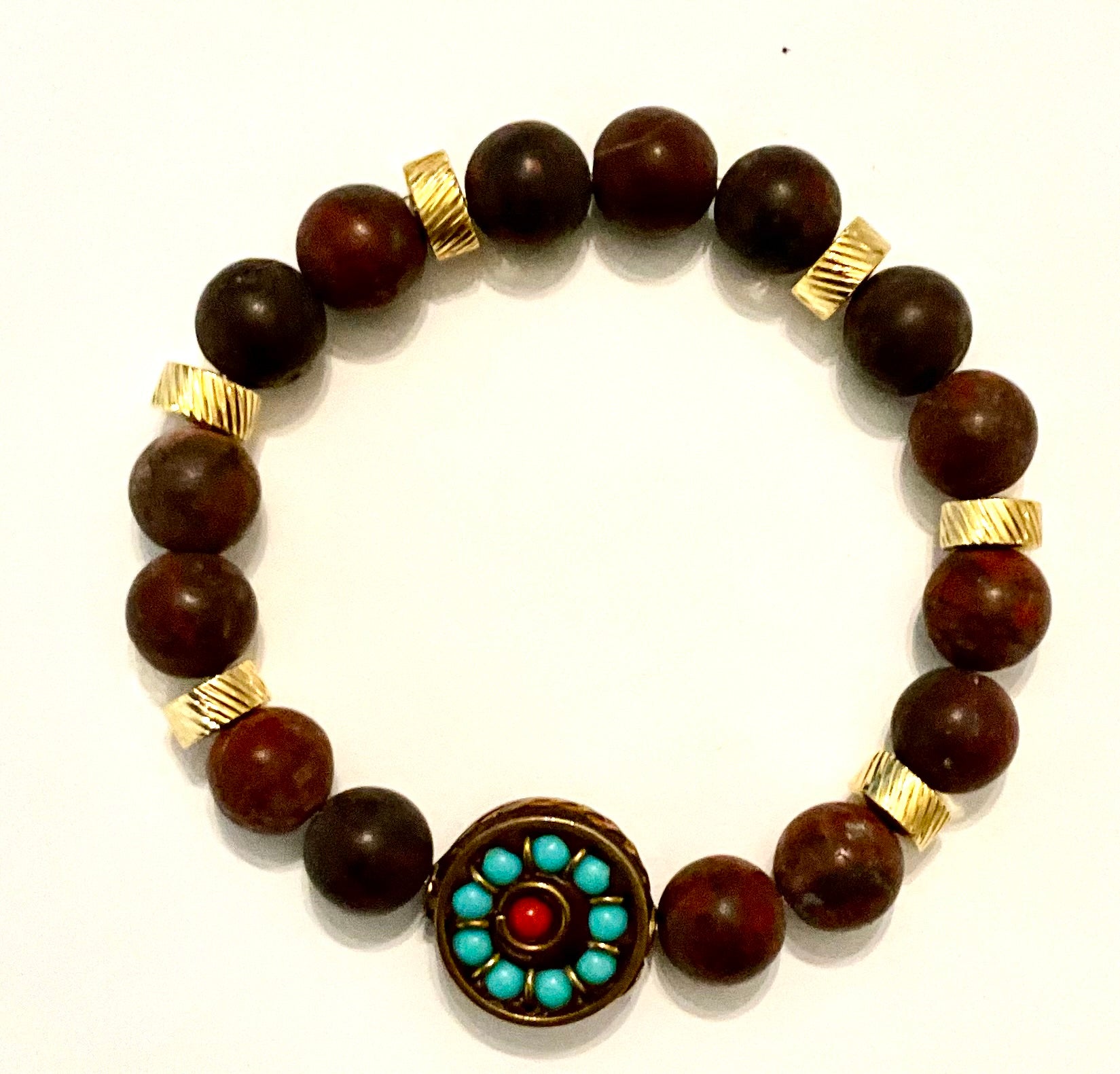 Bracelet with brown beads and a decorative clasp on a white background