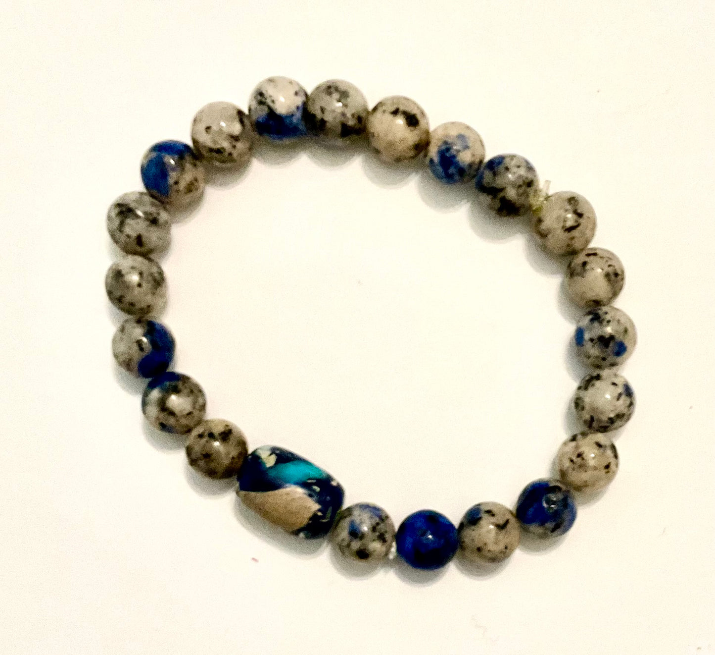 Beaded bracelet with blue and gray beads on a white background