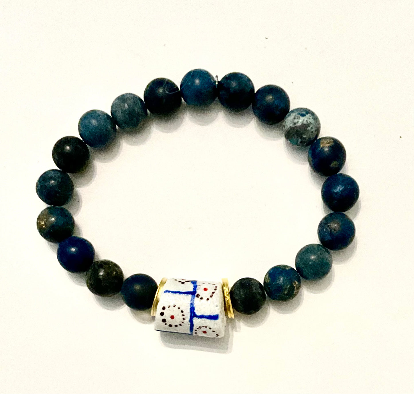 Beaded bracelet with a decorative bead on a white background
