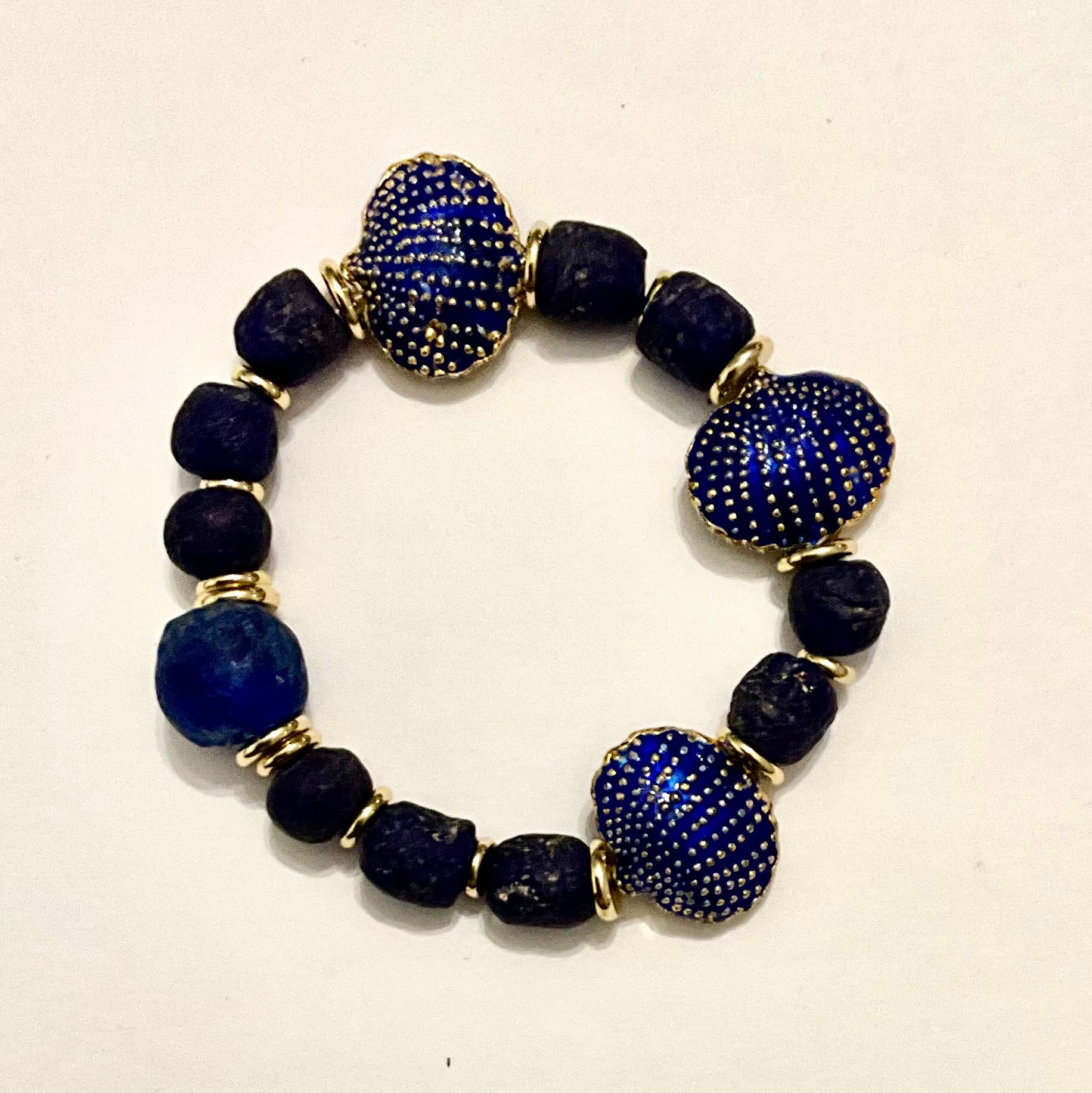 Bracelet with blue and black beads on a white background