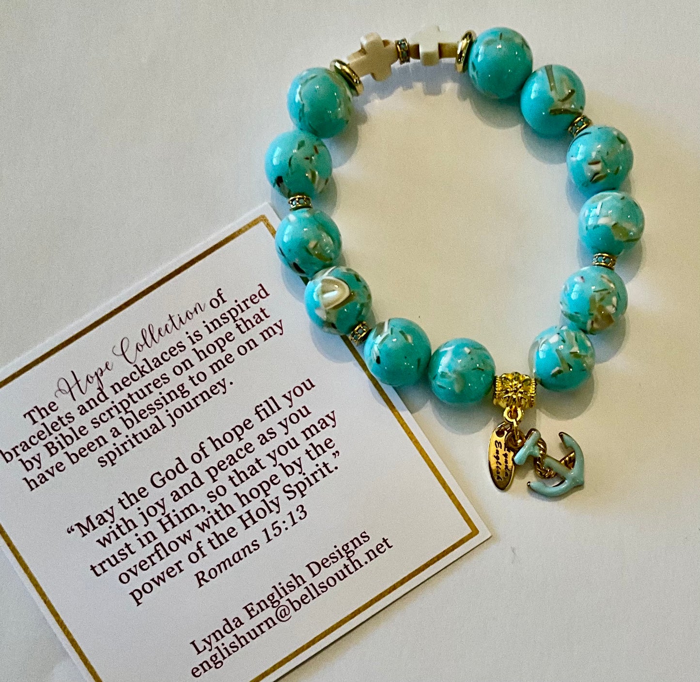 Turquoise beaded bracelet with gold accents on a white card with text