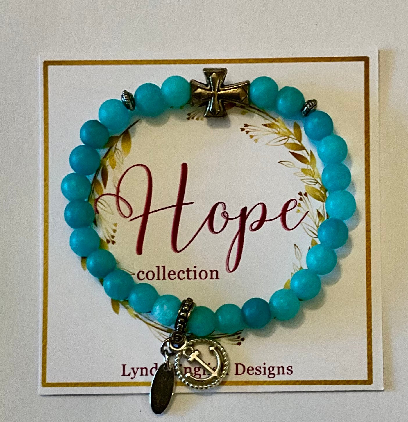 Turquoise beaded bracelet with anchor charm on a 'Hope collection' card by Lyndsay Designs.