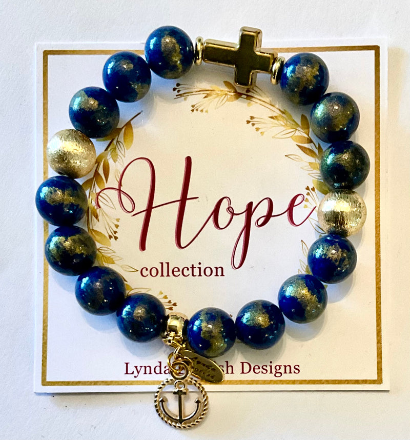 Blue beaded bracelet with gold accents on a 'Hope collection' card by Lyndsay French Designs.