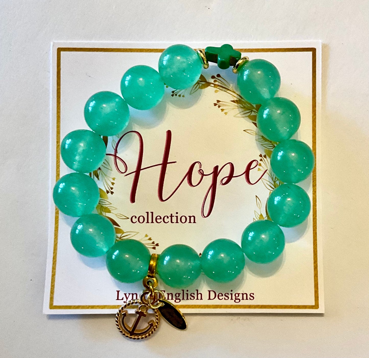 Green beaded bracelet with a leaf charm on a 'Hope collection' card by Lyn English Designs.