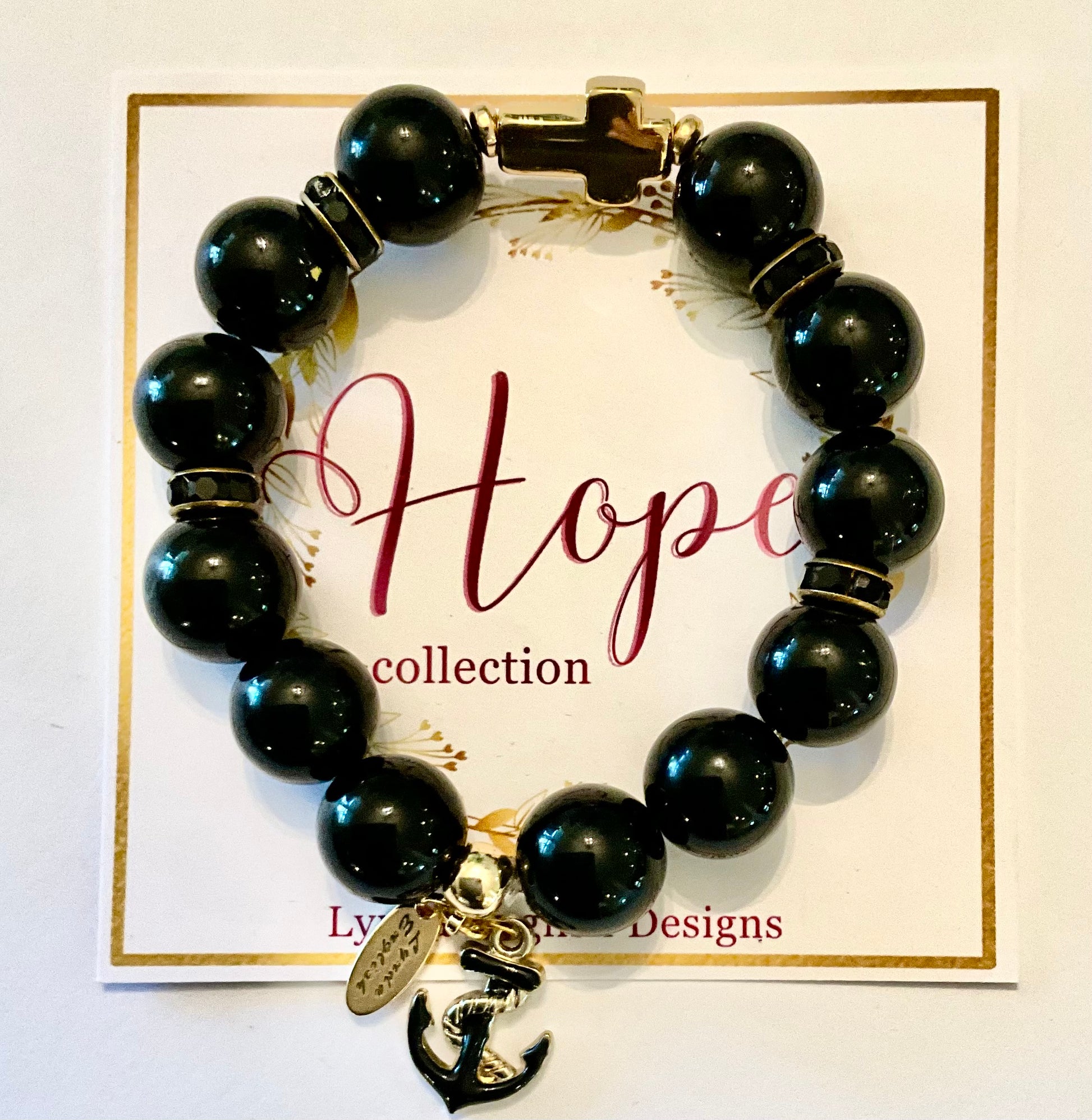 Black beaded bracelet with a charm on a 'Hope collection' card