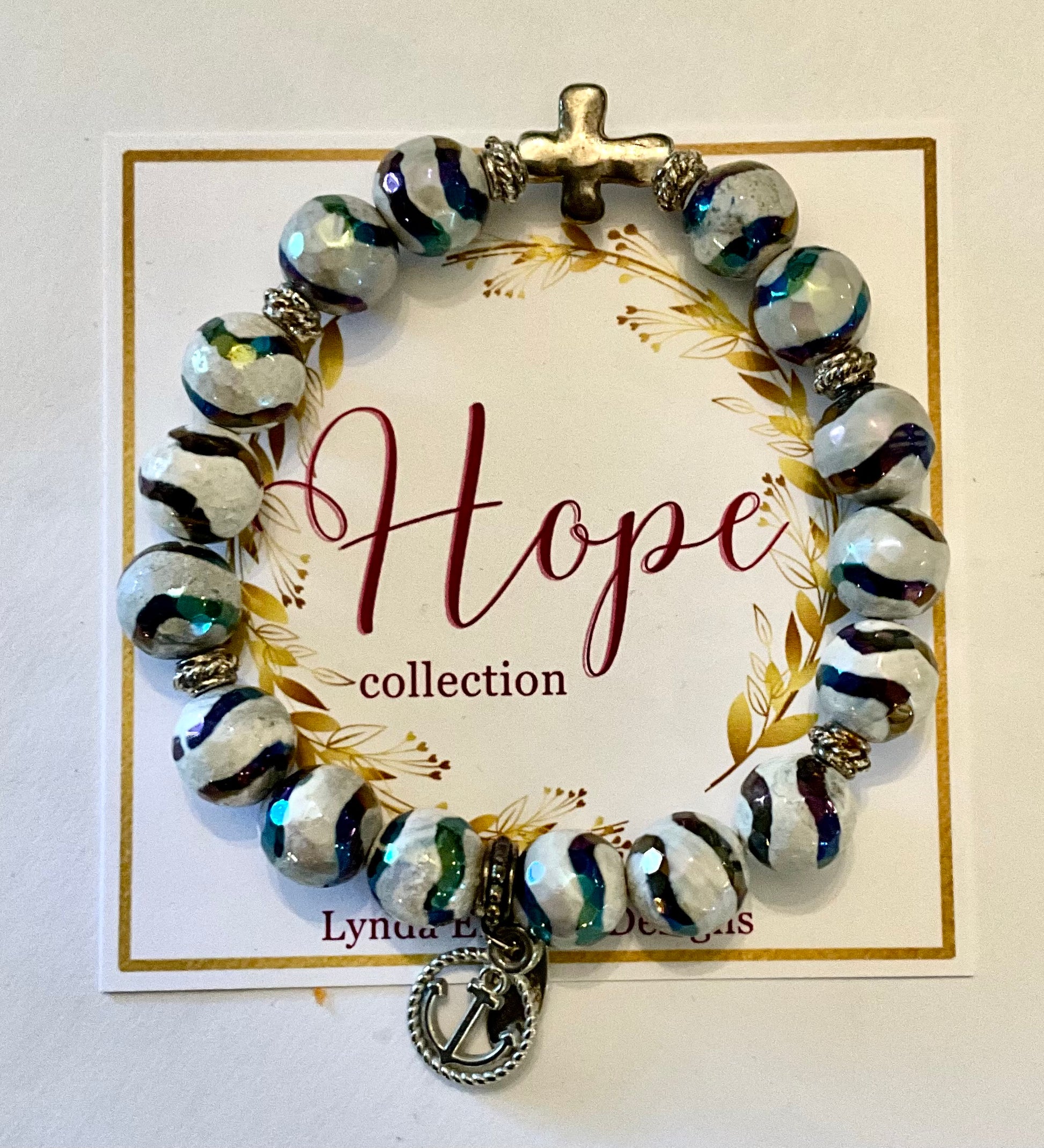 Beaded bracelet with a cross charm on a 'Hope collection' card